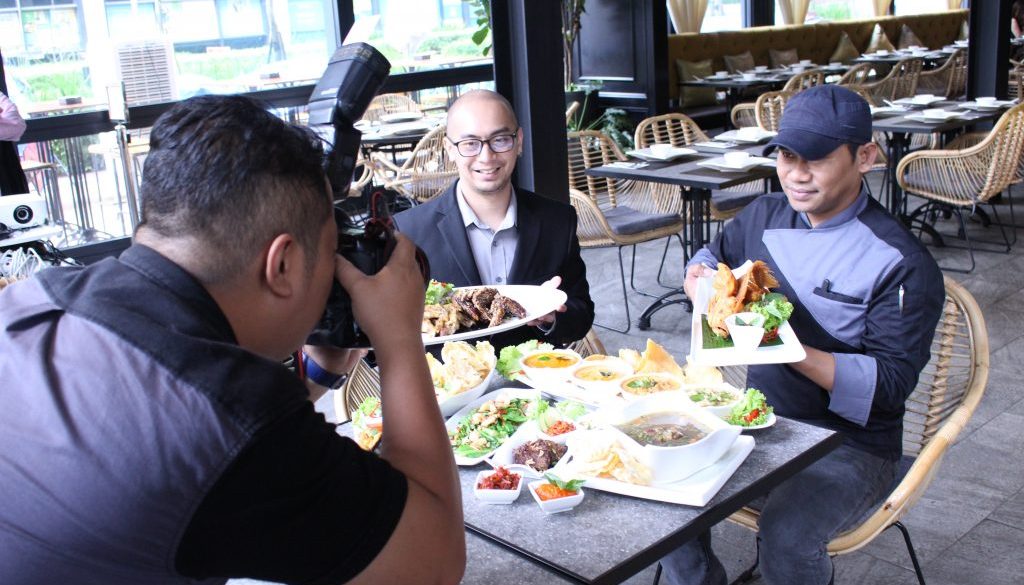 A photographer taking a photo at a Media Review session