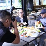 A photographer taking a photo at a Media Review session